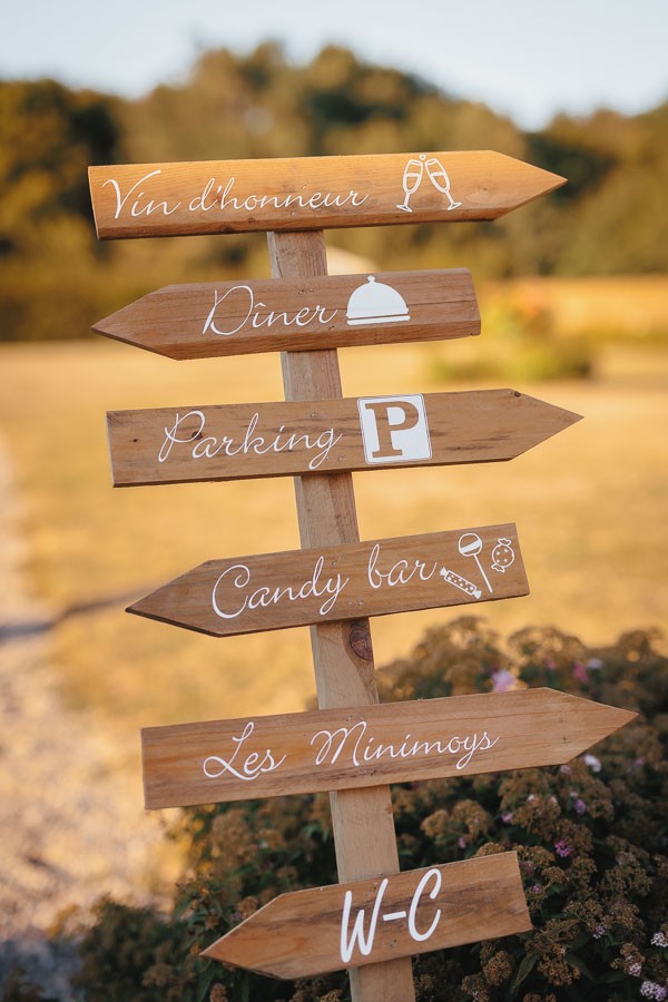 Un panneau en bois indique les directions lors d'un mariage au château de la Sébrandière en Vendée